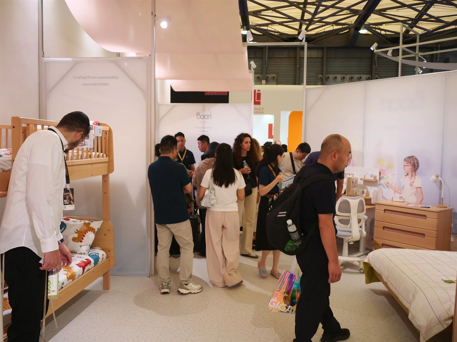 manufacturer explaining wooden bunk bed to buyers at Cologne kids furniture trade fair manufacturer explaining wooden bunk bed to buyers at Cologne kids furniture trade fair